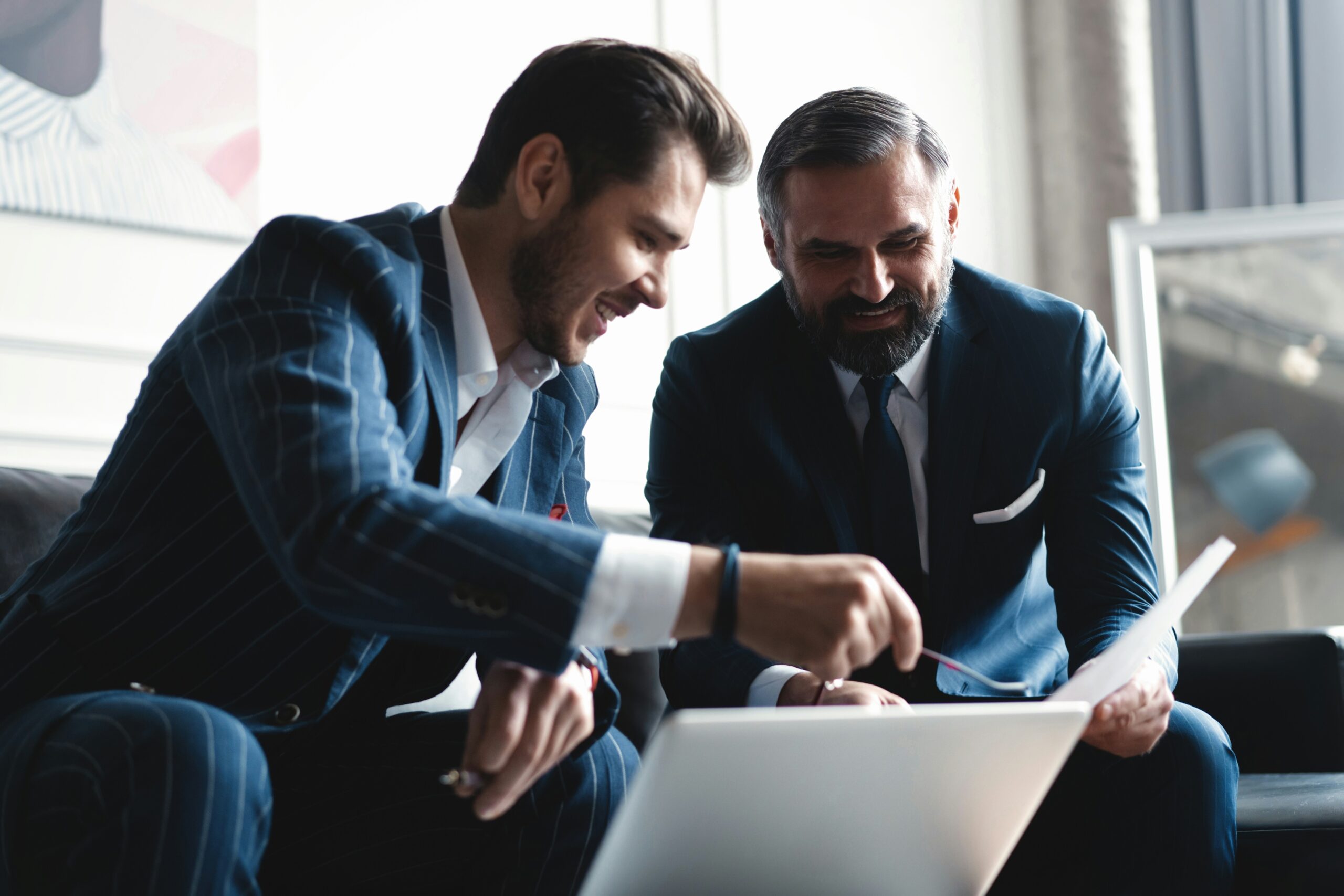 Banquier privé conseillant un client sur une stratégie patrimoniale avec analyse de documents